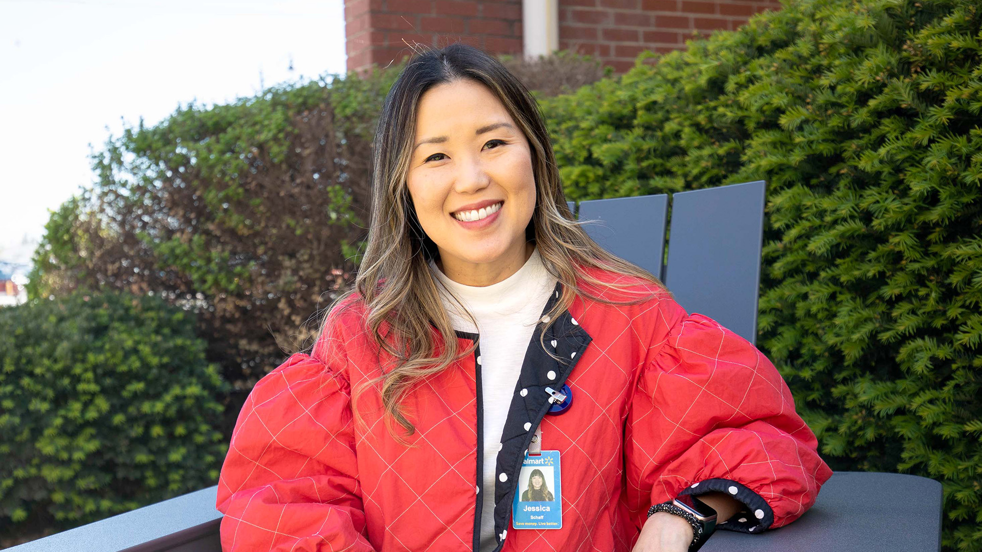 Jessica Schaff, vice president of digital acceleration, fashion at Walmart and proud Korean American, smiles seated outside.