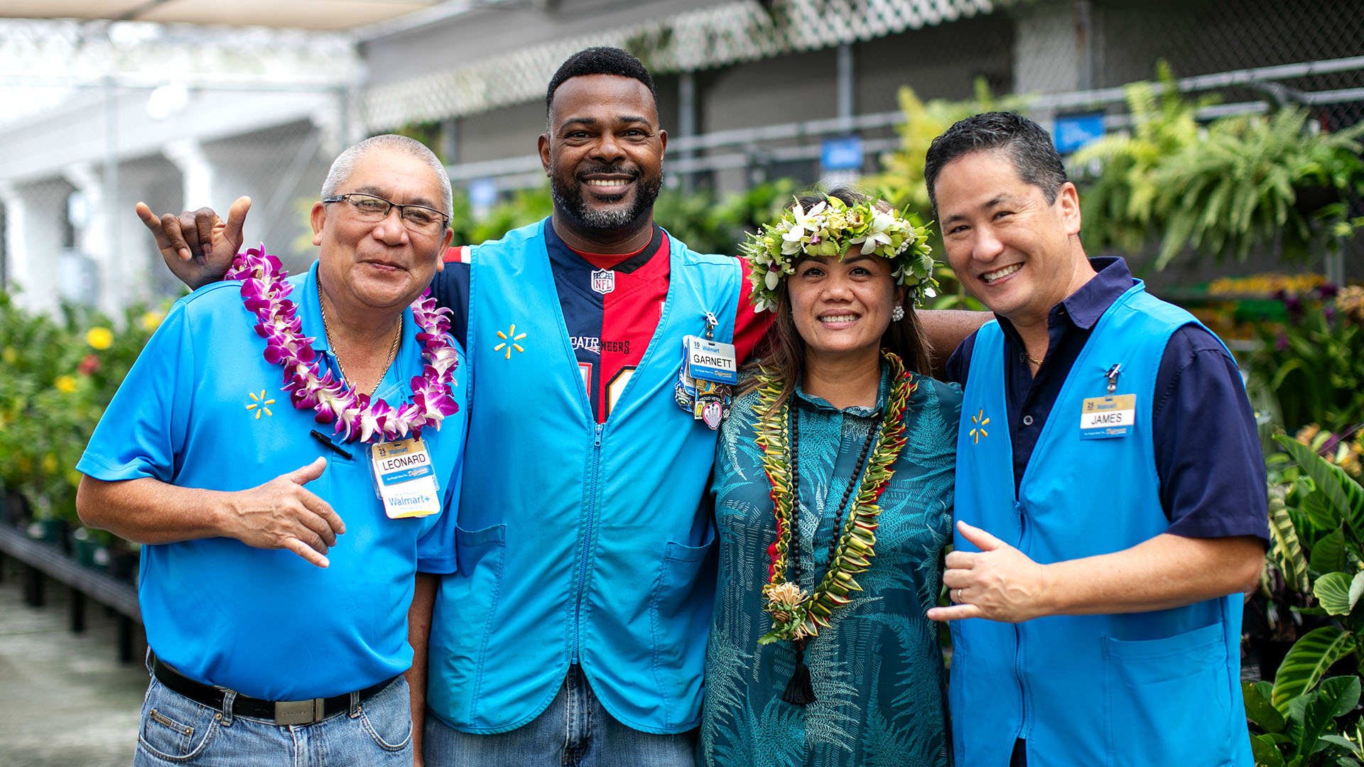 Associates pose wearing leis and making the shaka or “hang loose” sign at the Hilo Walmart’s grand re-opening celebration.