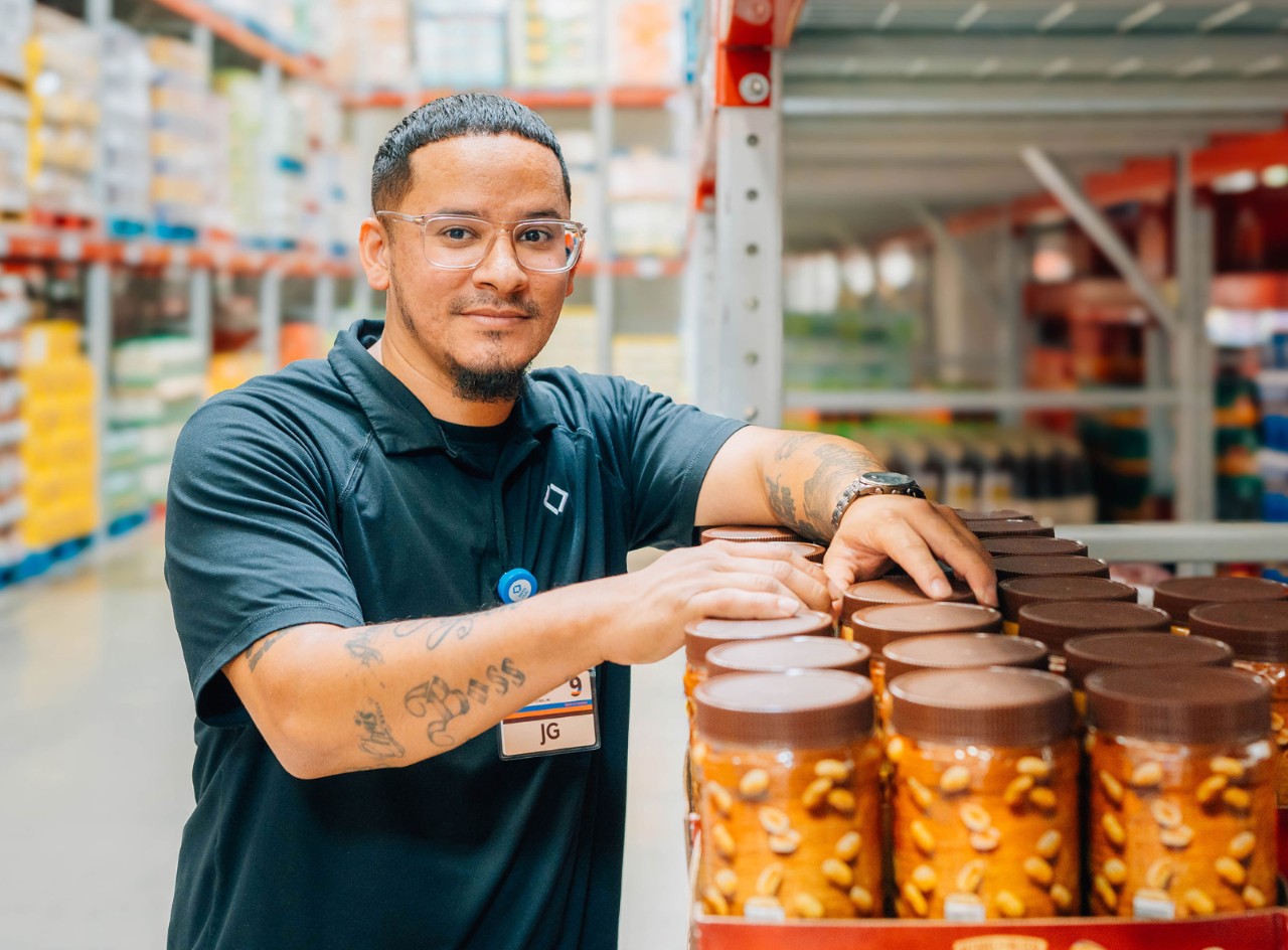 Sam’s Club Manager Justin Garcia looks up from stocking shelves.