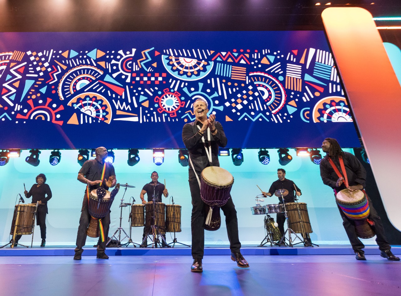 Members of The Drum Cafe play djembes on the Sam’s Club Meeting stage to rev up the crowd at Associates Week 2025.