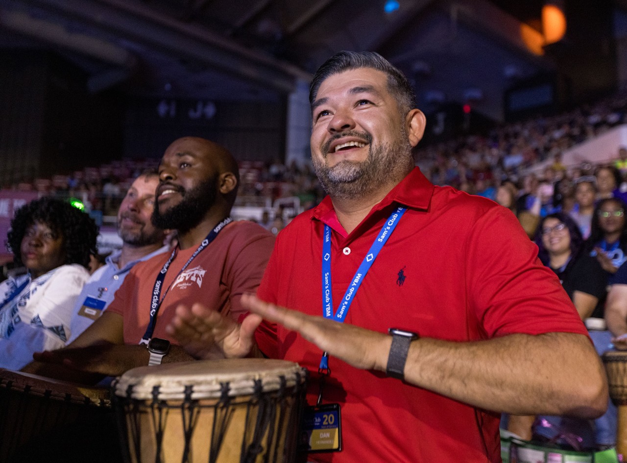 Associates in the audience at the Sam’s Club Meeting drum along in a call-and-response exercise that energizes the crowd.