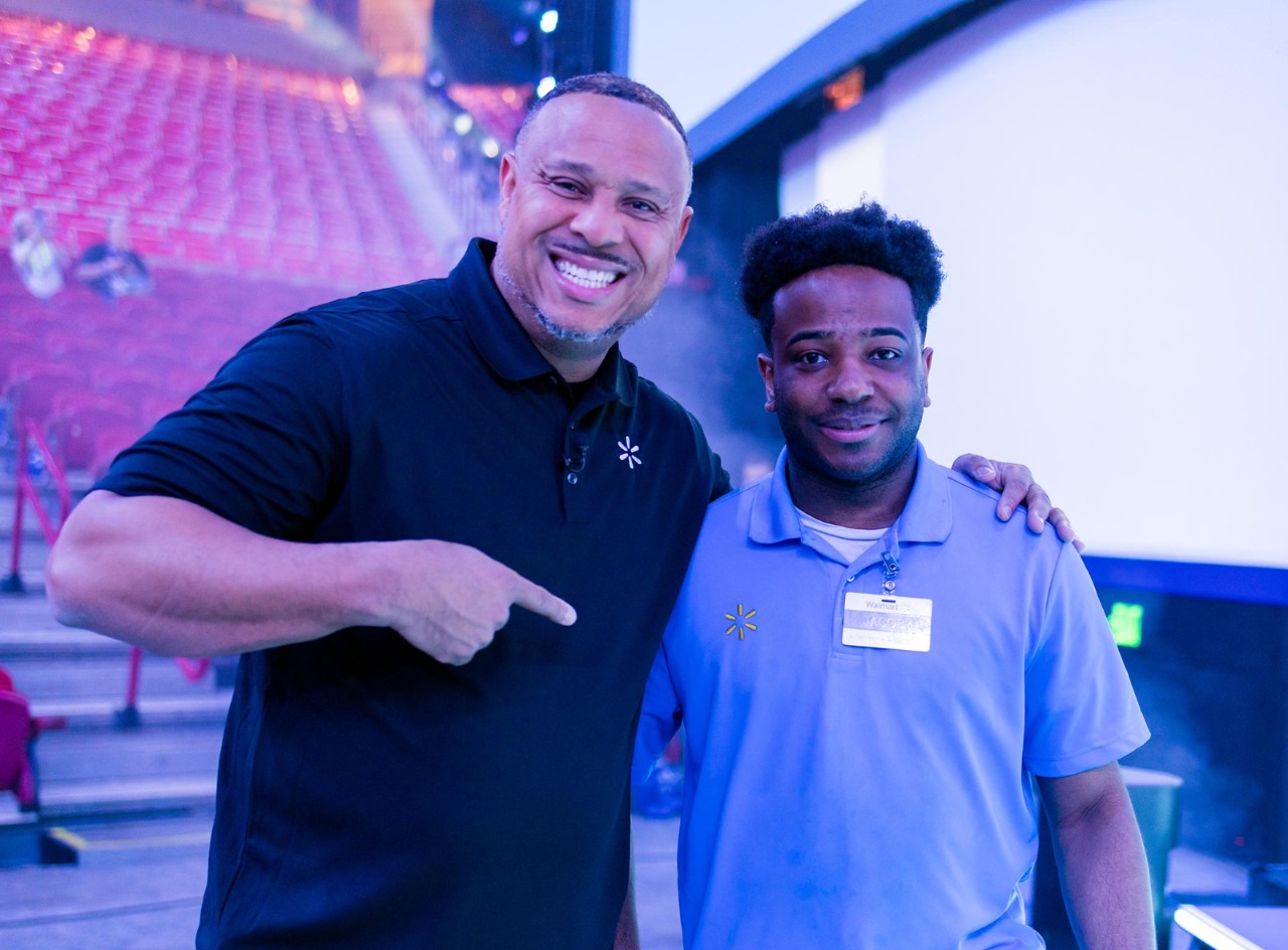 Executive Vice President Cedric Clark poses with Overnight Stocker Jacoby Brown at the Walmart U.S. Meeting.