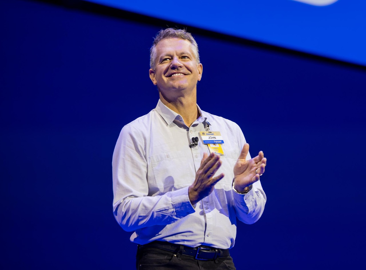 Walmart U.S. CEO John Furner smiles on stage at Associates Week 2025.